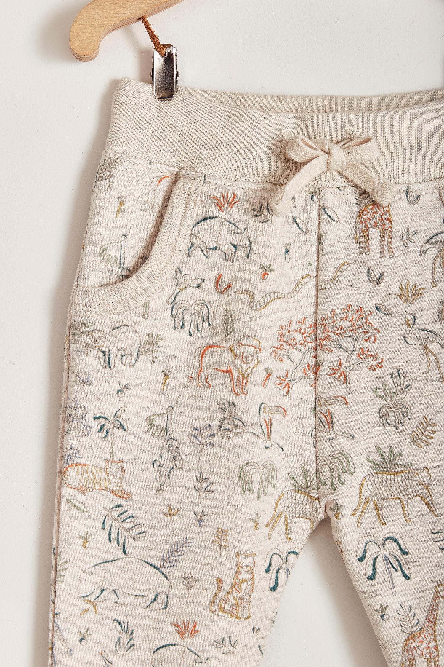 Safari Jogger pants are perfect for everyday! Comfy and stylish for every season, it features an elasticated inner waist and contrasting drawstring to fit. Pockets on the front. Combine it with any of our Pima Colour bodysuits and Safari's jumper for a complete look. Colour: Beige melange with coloured details. Composition: 95% Peruvian Pima cotton, 5% Elastane.  Made in Peru. Machine wash cold.