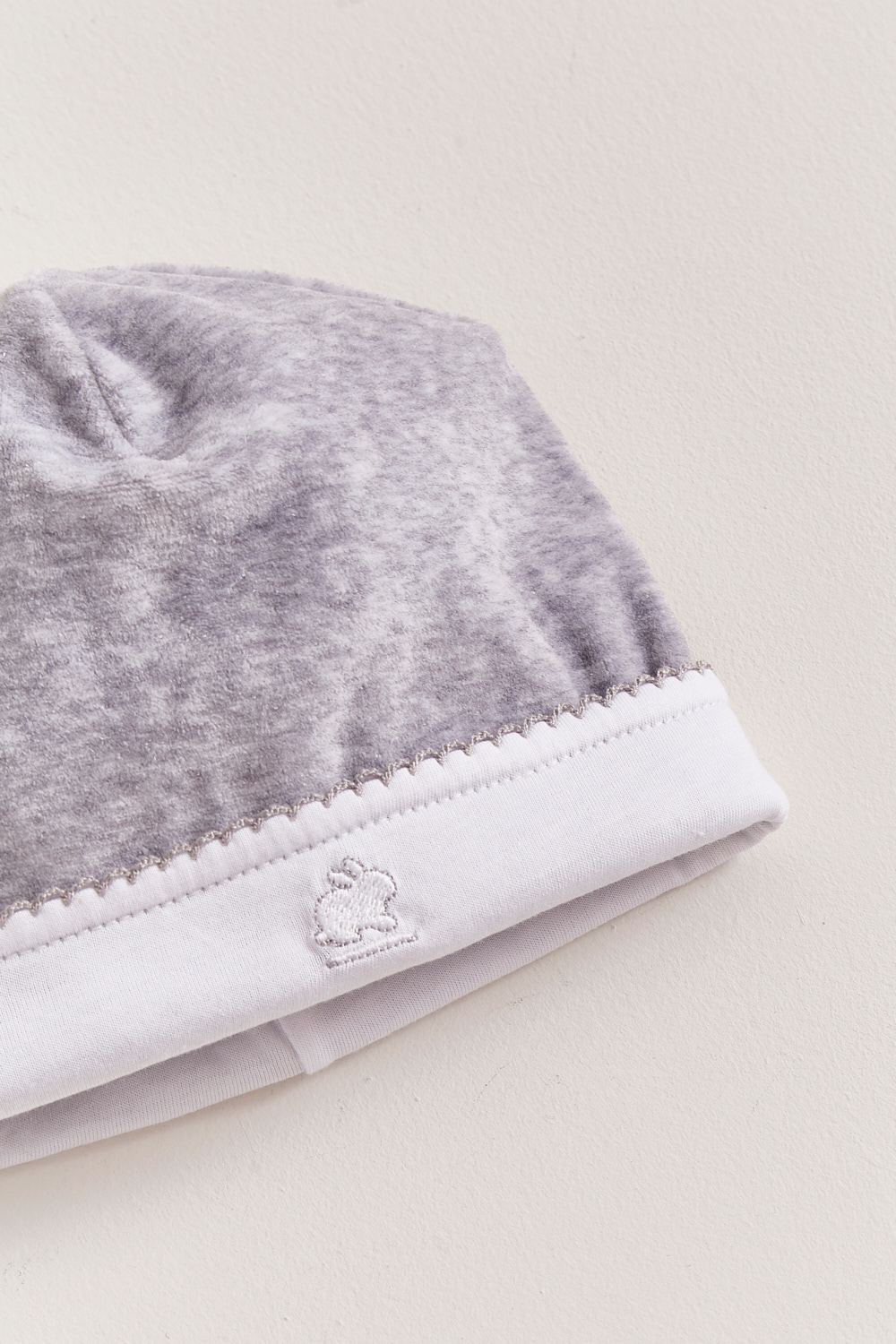 Soft plush grey fabric that keeps your little one comfortable and warm. Embroidered logo. A perfect beanie for those chilly nights!