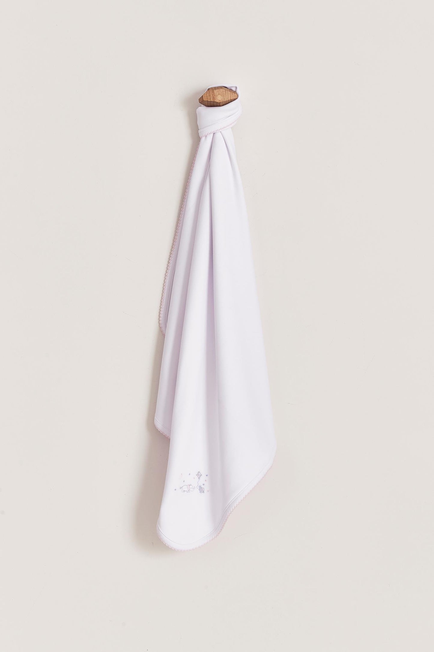 Crafted from super soft Pima cotton, this receiving blanket makes babies first months extra cozy. This two sided blanket features a sleek white finish with an embroidered of Celine & Bernie, while the other side comes with a full print of our Celine & Bernie collection. Composition: 100% Peruvian Pima Cotton. Made in Peru. Machine washable.