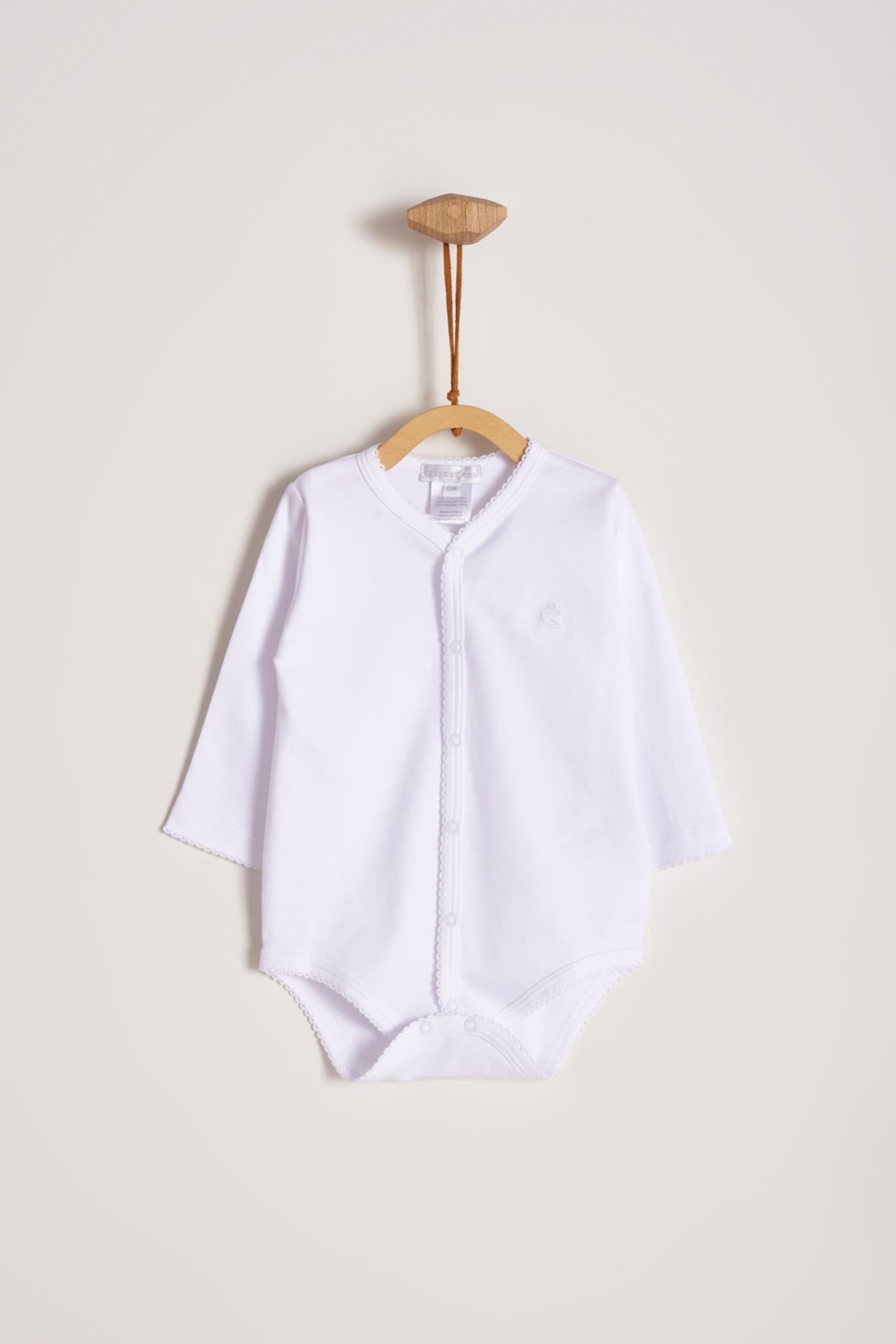 This baby basic long sleeve snapped bodysuit made with 100% super soft and resistant Pima cotton is a must have for your little one. Features a delicate embroidered neckline and sleeves alongside our sweet logo bunny. A baby's wardrobe essential! Popper fastenings around the legs and the front make changing easy, too. Colour: White. Composition: 100% Peruvian Pima Cotton.  Made in Peru.  Machine washable.