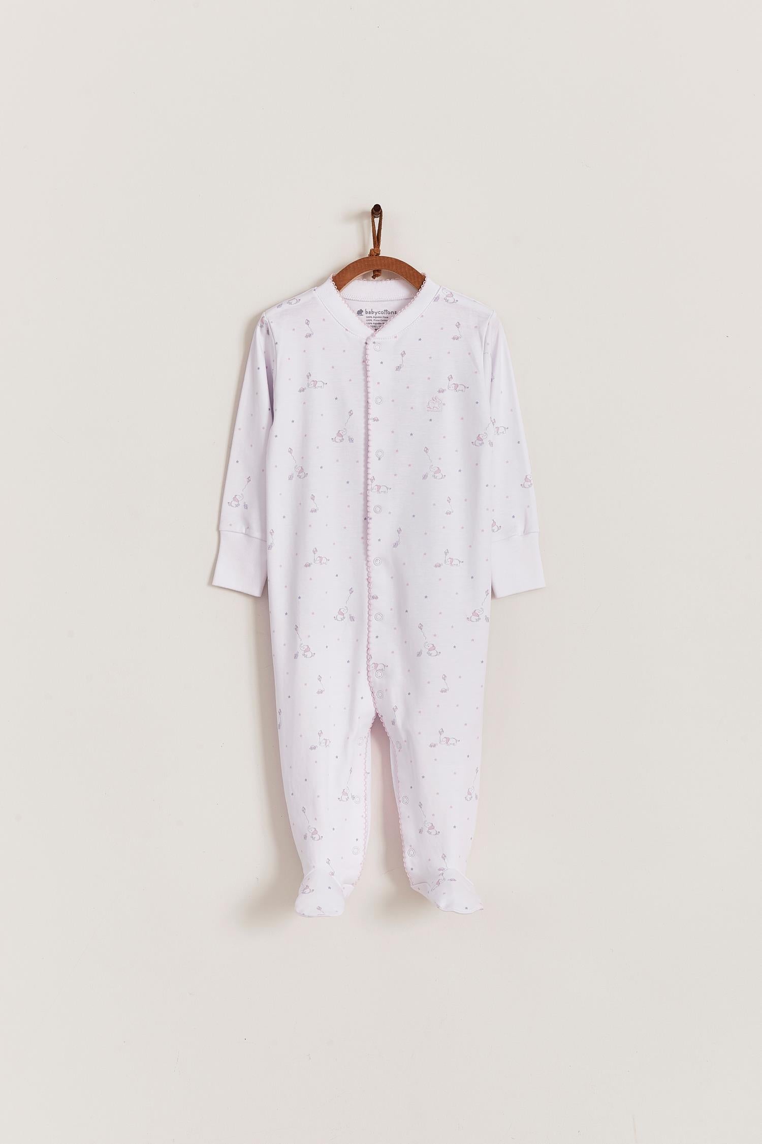 Super soft Pima cotton, long-sleeve, footed pyjama with full snap closure. The pyjama has delicate picot edging and it features our lovely Celine & Bernie print! In size NB, the cuffs give the option of making them mittens for the baby's first days, and can then be folded again. Colour: White with pink. Composition: 100% Peruvian Pima Cotton.  Made in Peru. Machine washable. Safety warning: Keep away from fire.
