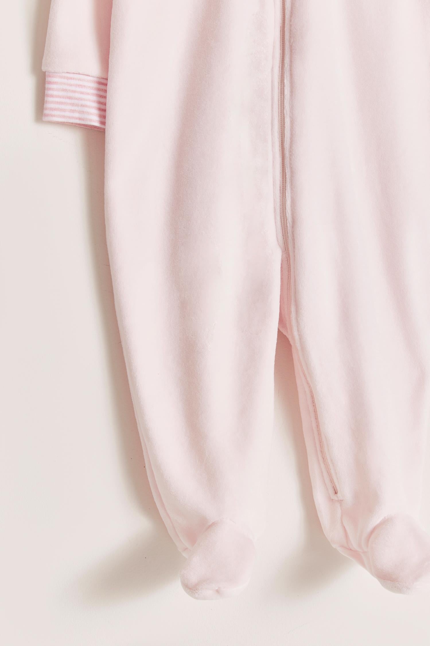 Super warm and soft plush pyjama, ideal to stay warm and comfortable during winter!  With long-sleeves, footed and with front closure.  Features a lovely striped ribbed collar and cuffs, alongside an embroidered patch on the front.  Colour: Pink. Composition: 85% Peruvian Pima cotton, 15% polyester. Made in Peru. Machine washable. Safety warning: Keep away from fire.