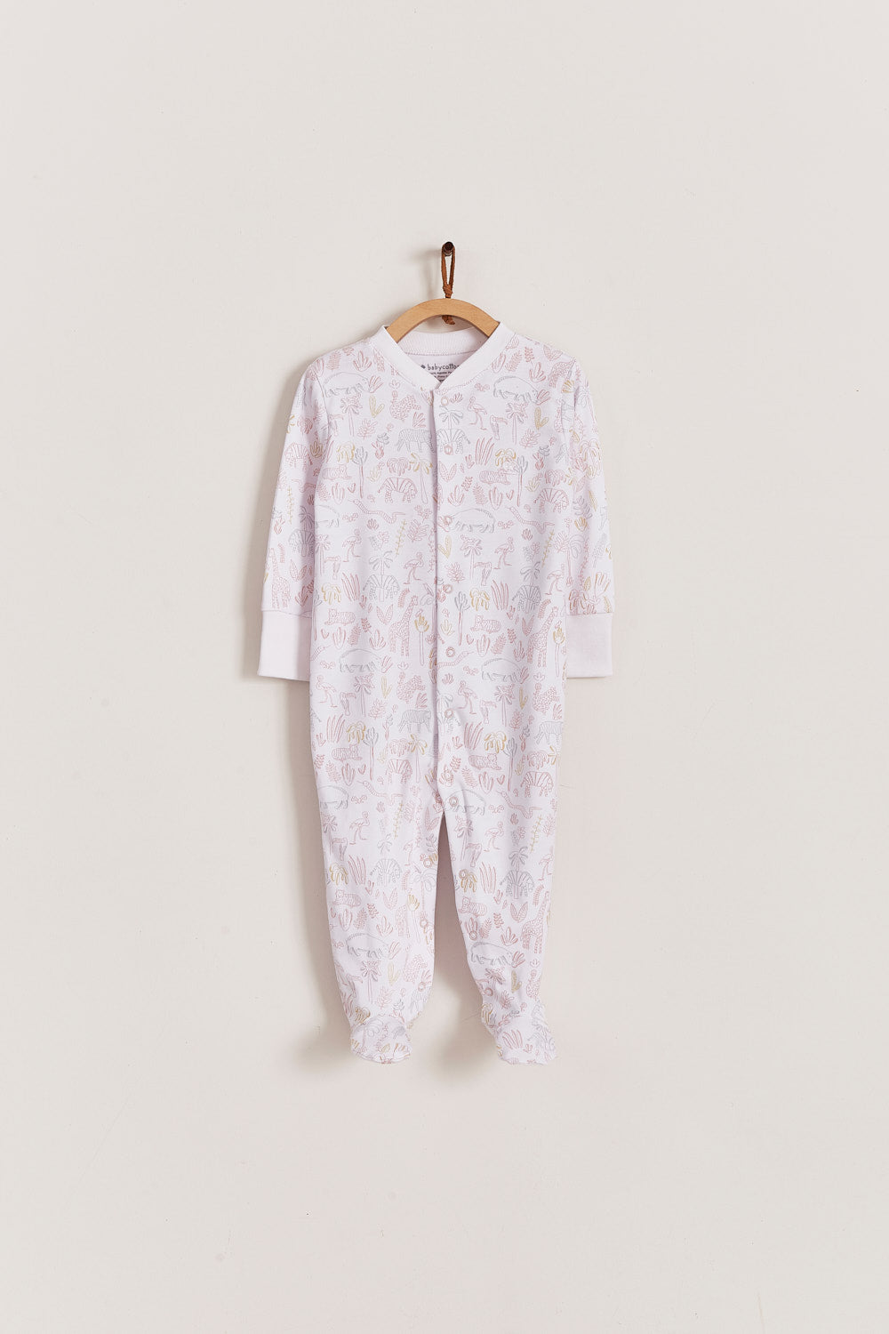 Super soft Pima cotton, long-sleeve, footed pyjama with full snap closure. The pyjama has delicate picot edging and it features an all over Safari print, very cool and fresh! In size NB, the cuffs give the option of making them mittens for the baby's first days, and can then be folded again. Colour: White with light-pink, grey and mustard. Composition: 100% Peruvian Pima Cotton.  Made in Peru. Machine washable. Safety warning: Keep away from fire.