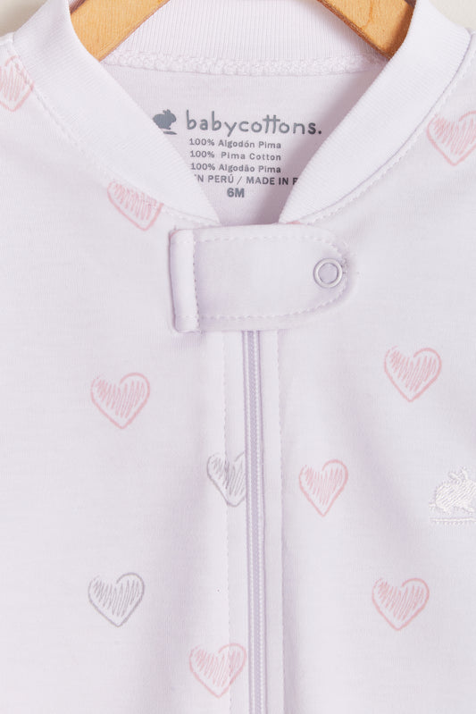 Hearts is classic, cute and perfect for naptime!  Your little one can grow with it and wear it for a longest time. With zipper added for more comfort and practicality. Starting in 12 months all our footies are snug fit. Colour: White with pink and grey details. Composition: 100% Peruvian Pima Cotton.  Made in Peru. Machine washable. Safety warning: Keep away from fire.