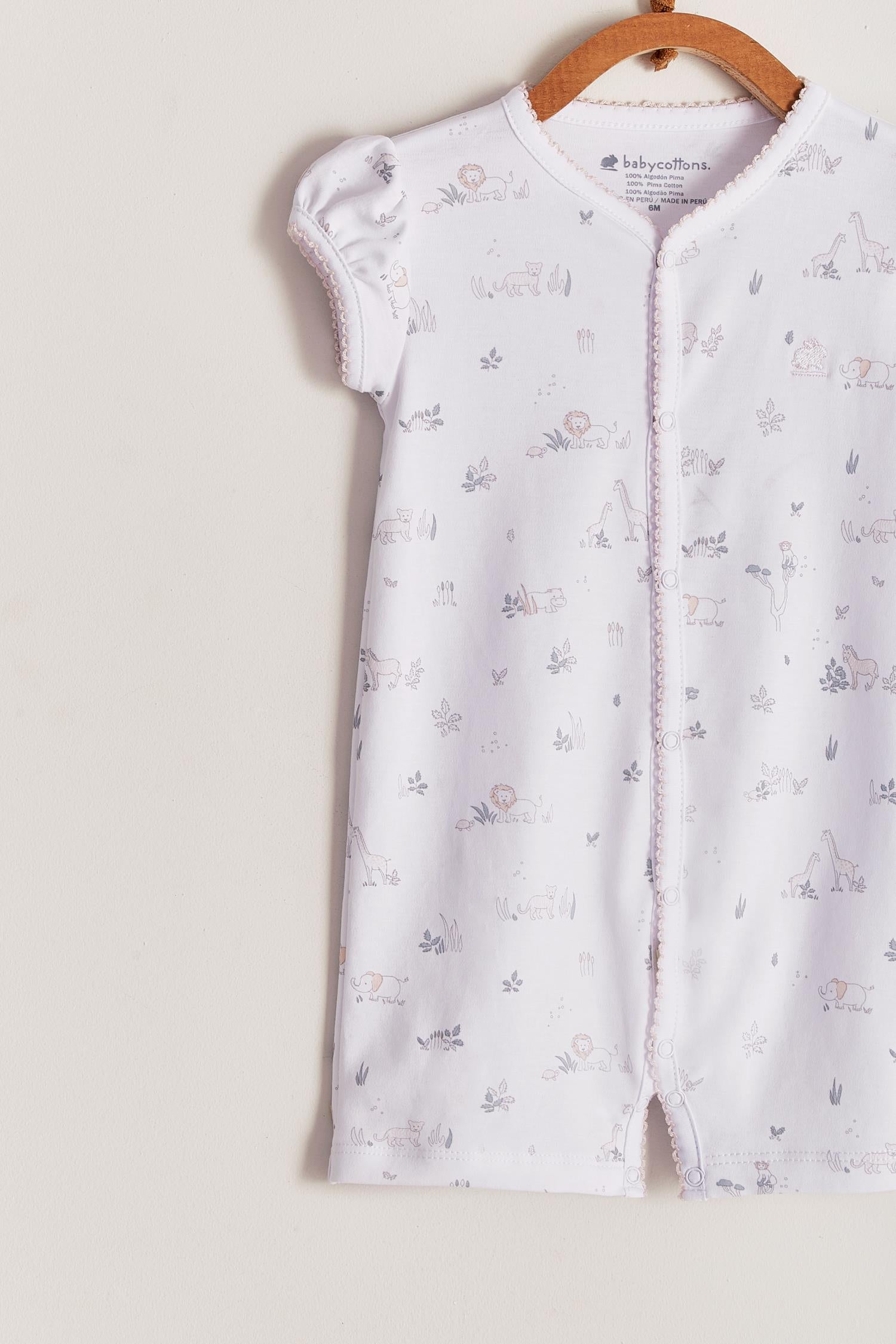 Comfy, cute and super soft, this Mini Safari short romper is the perfect addition to your baby's spring/summer wardrobe. Very versatile, the romper is perfect for playtime and nap-time! With full snap closure make it super easy to slip on. Match it with our Safari collection to make the perfect gift! Colour: White with grey and pink details. Composition: 100% Peruvian Pima Cotton.  Made in Peru. Machine washable. Safety warning: Keep away from fire.