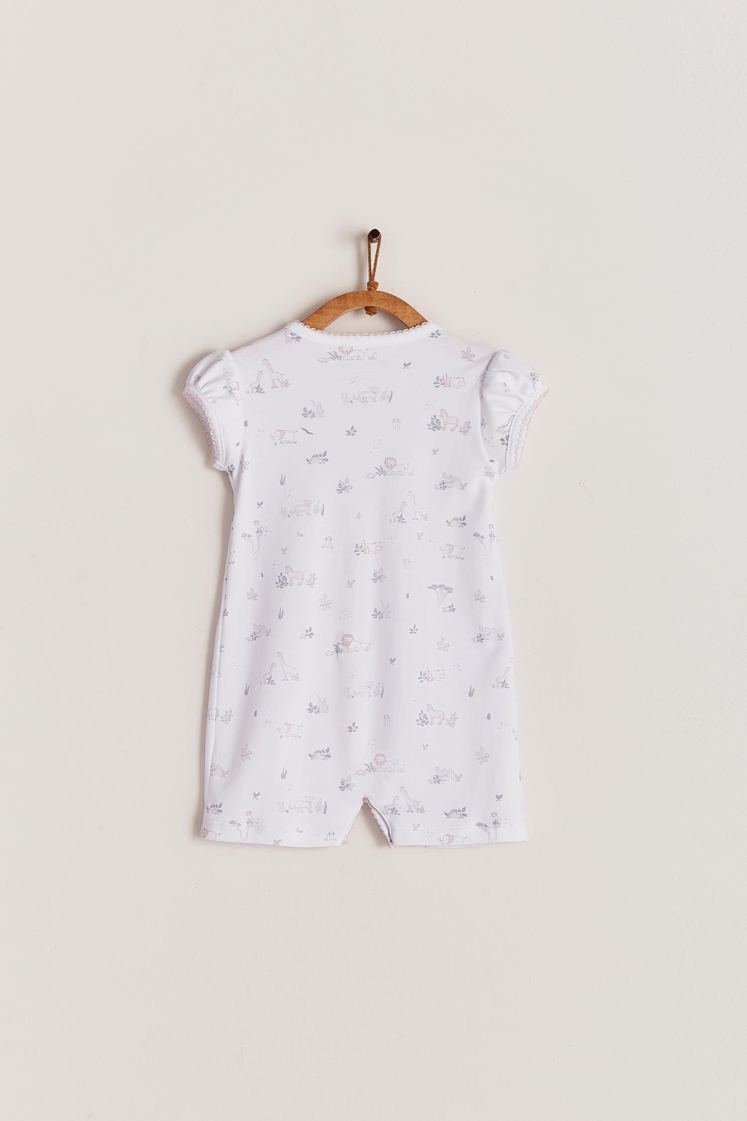 Comfy, cute and super soft, this Mini Safari short romper is the perfect addition to your baby's spring/summer wardrobe. Very versatile, the romper is perfect for playtime and nap-time! With full snap closure make it super easy to slip on. Match it with our Safari collection to make the perfect gift! Colour: White with grey and pink details. Composition: 100% Peruvian Pima Cotton.  Made in Peru. Machine washable. Safety warning: Keep away from fire.