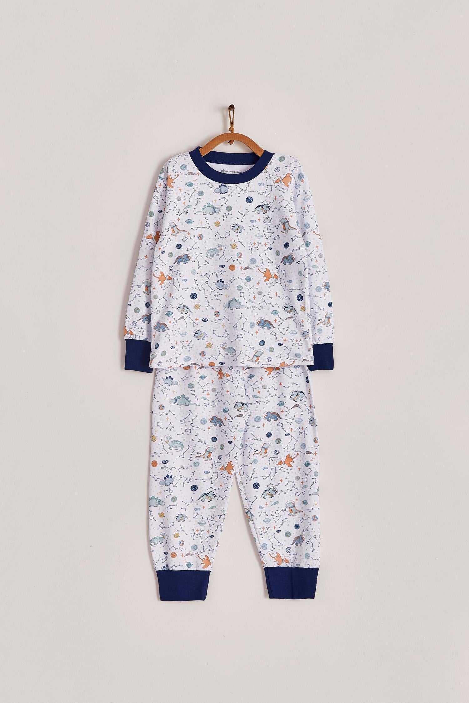 Our full print Space Dinos pyjama set is colourful, cute and fun! This 100% Pima Cotton pyjama is super soft and comfortable ideal for sleep but also playtime at home. With long-sleeves with long-pants, it's perfect for any season! Makes an ideal gift! Colour: White with blue, light-blue and orange details. Composition: 100% Peruvian Pima Cotton.  Made in Peru. Machine washable. Safety warning: Keep away from fire.