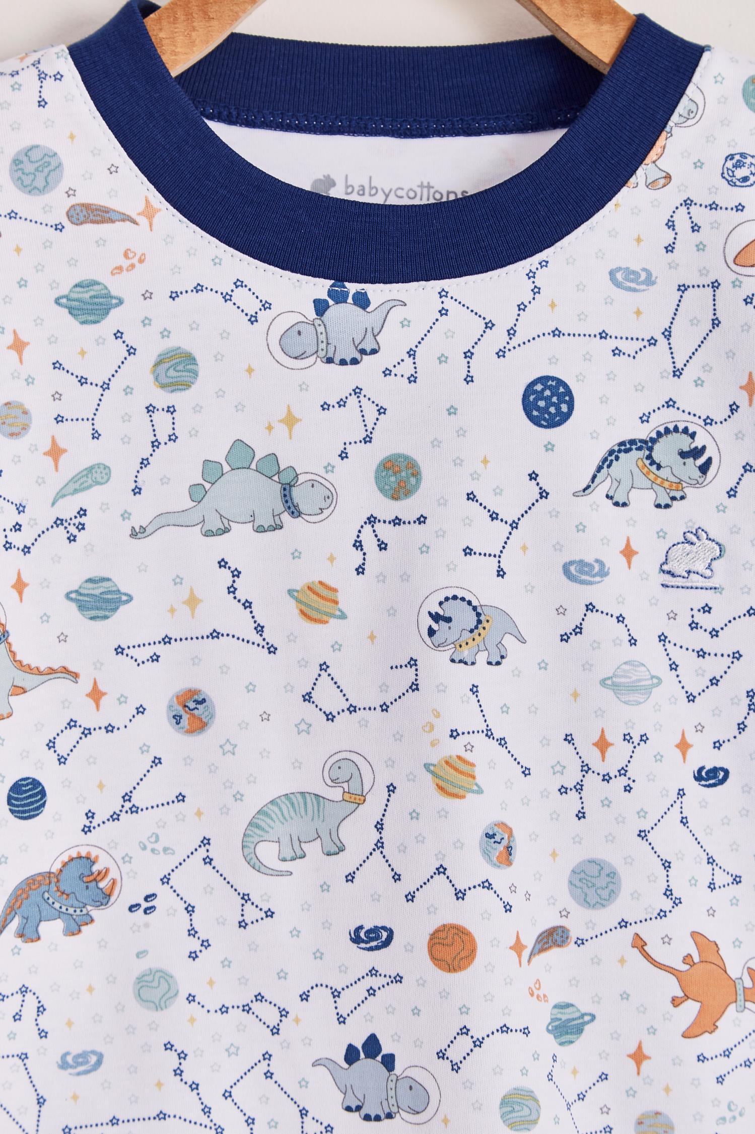 Our full print Space Dinos pyjama set is colourful, cute and fun! This 100% Pima Cotton pyjama is super soft and comfortable ideal for sleep but also playtime at home. With long-sleeves with long-pants, it's perfect for any season! Makes an ideal gift! Colour: White with blue, light-blue and orange details. Composition: 100% Peruvian Pima Cotton.  Made in Peru. Machine washable. Safety warning: Keep away from fire.