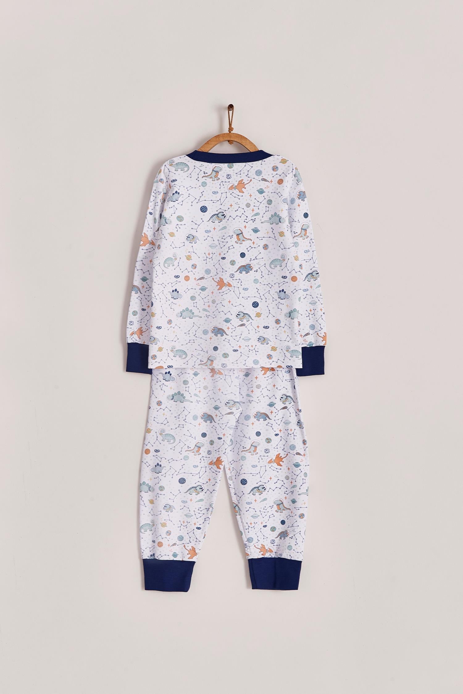Our full print Space Dinos pyjama set is colourful, cute and fun! This 100% Pima Cotton pyjama is super soft and comfortable ideal for sleep but also playtime at home. With long-sleeves with long-pants, it's perfect for any season! Makes an ideal gift! Colour: White with blue, light-blue and orange details. Composition: 100% Peruvian Pima Cotton.  Made in Peru. Machine washable. Safety warning: Keep away from fire.