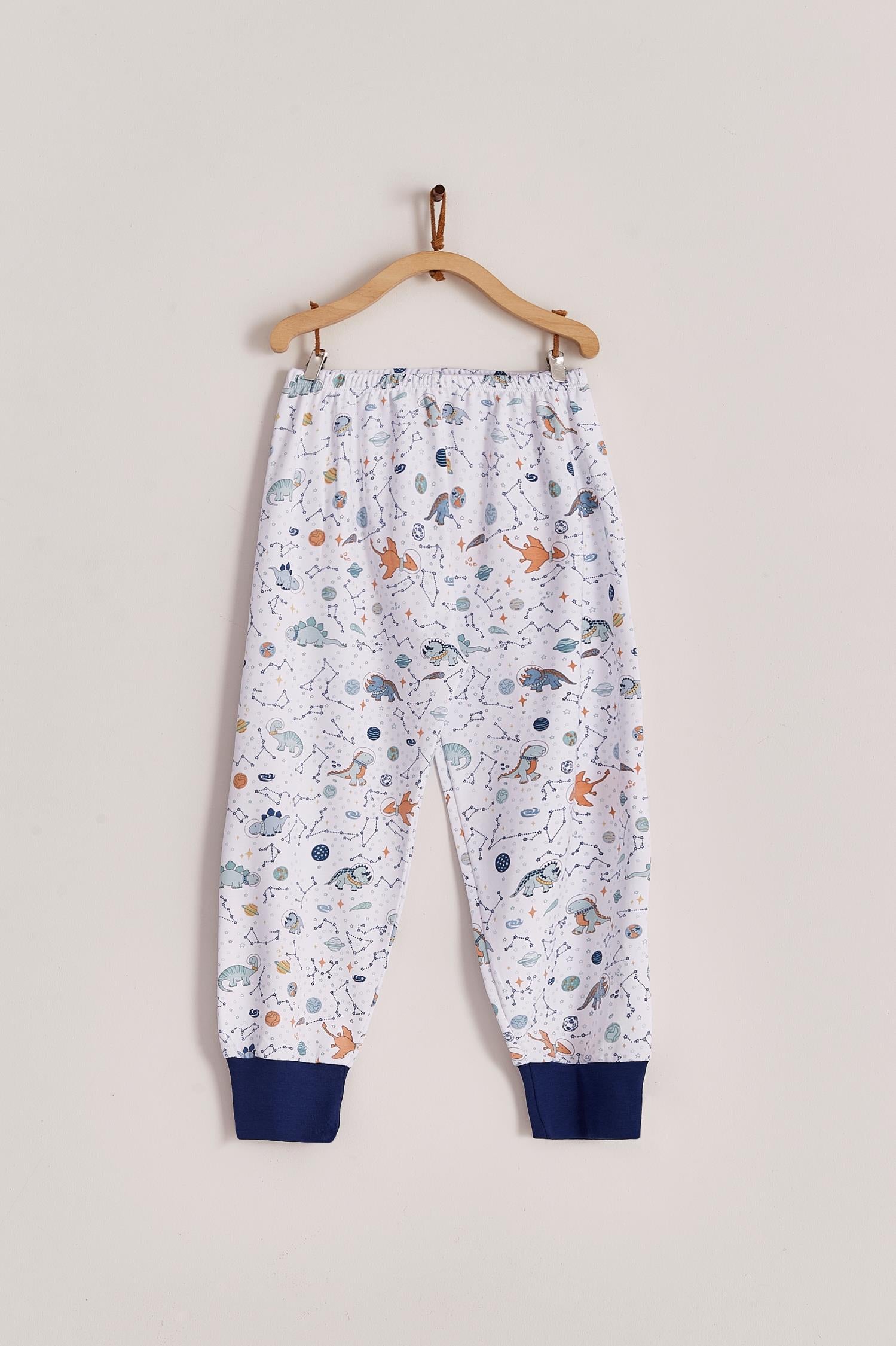 Our full print Space Dinos pyjama set is colourful, cute and fun! This 100% Pima Cotton pyjama is super soft and comfortable ideal for sleep but also playtime at home. With long-sleeves with long-pants, it's perfect for any season! Makes an ideal gift! Colour: White with blue, light-blue and orange details. Composition: 100% Peruvian Pima Cotton.  Made in Peru. Machine washable. Safety warning: Keep away from fire.