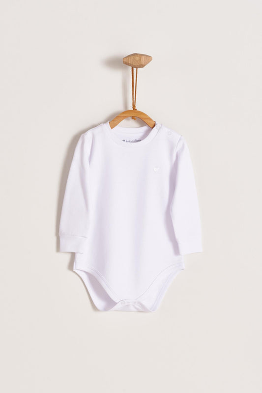 Pima cotton, long-sleeved, t-shirt collar bodysuit. Perfect for a casual look! Poppers on the shoulder and crotch: handy when getting baby dressed. A baby's wardrobe must-have available in a range of colours.  Colour: White. Composition: 100% Peruvian Pima Cotton.  Made in Peru. Machine washable.