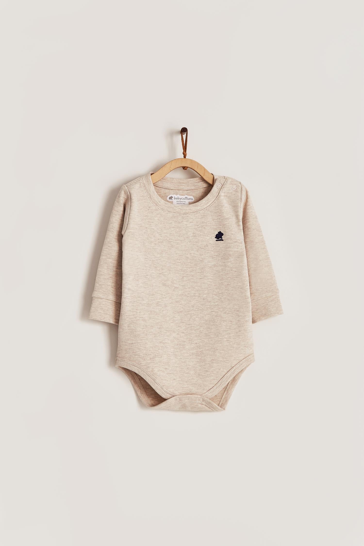 Pima cotton, long-sleeved, t-shirt collar bodysuit. Perfect for a casual look! Poppers on the shoulder and crotch: handy when getting baby dressed. A baby's wardrobe must-have available in a range of colours. Colour: Beige melange. Composition: 100% Peruvian Pima Cotton.  Made in Peru. Machine washable.