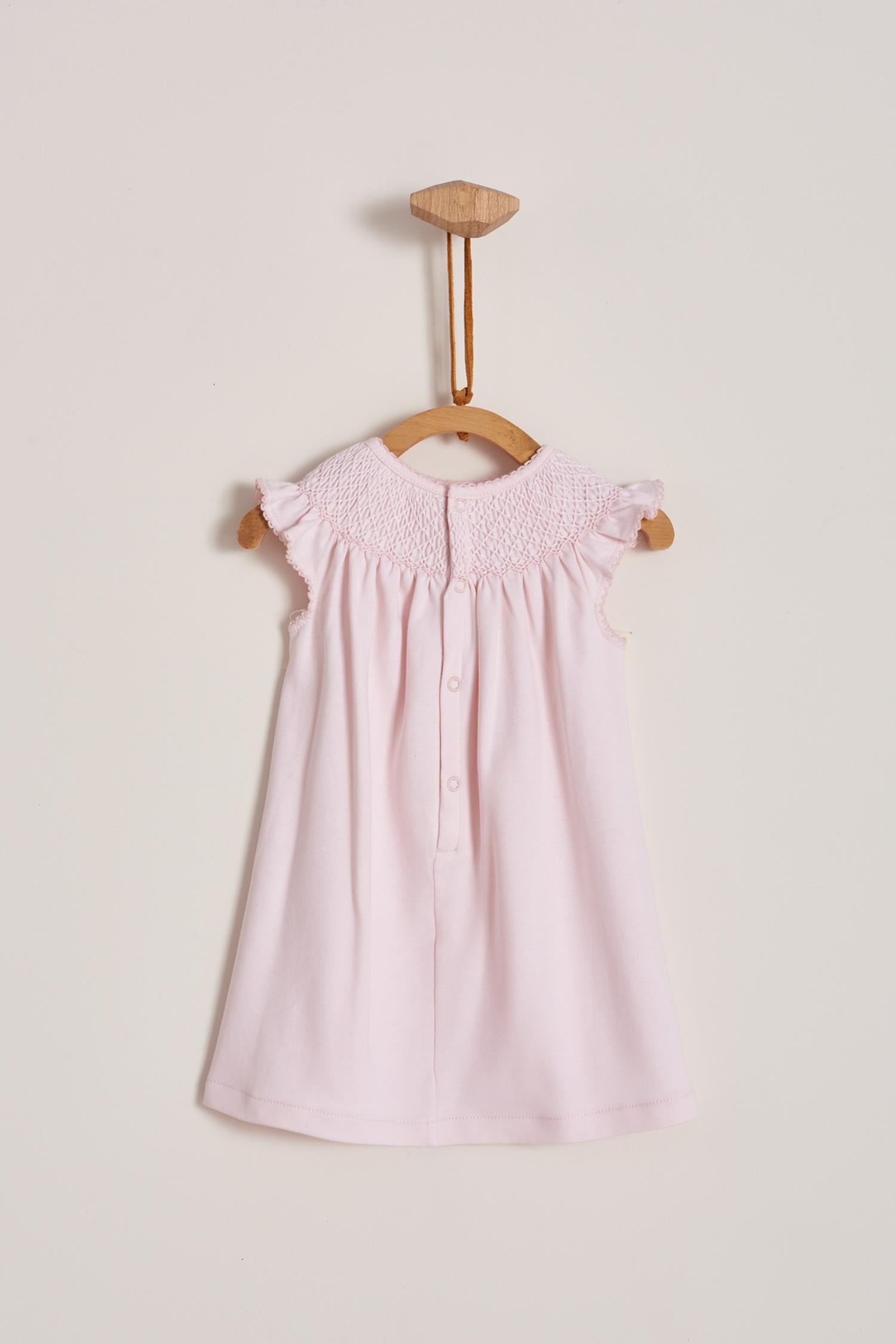 This is definitely the prettiest, effortless and softest 100% Pima Cotton dress for your little girl! The smock at the front makes it super stylish, a must-have for a baby girl spring-summer wardrobe. Comes with matching knickers to cover the nappy.  Makes an ideal gift! Colour: Pink Composition: 100% Peruvian Pima Cotton.  Made in Peru. Machine washable.