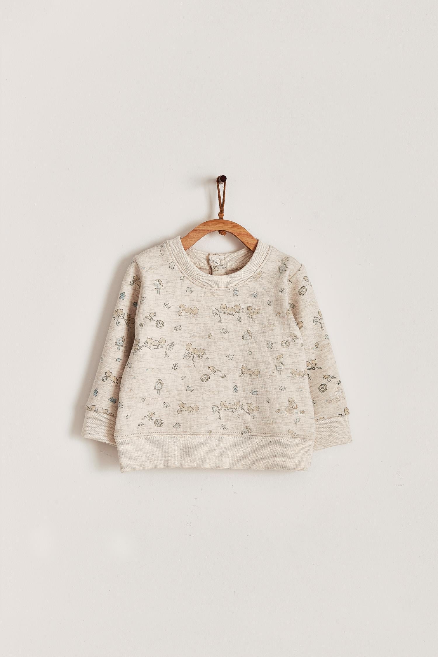 Keep your little one warm and comfortable with our baby sweatshirt, fully printed with our cute Odette Adventures collection. Round neckline and snaps closure at the back. Match it with our Odette pants for the sweetest look! Colour: Beige melange with light-brown and green details. Composition: 100% Peruvian Pima cotton.  Made in Peru. Machine wash cold. 