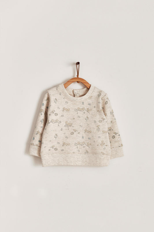 Keep your little one warm and comfortable with our baby sweatshirt, fully printed with our cute Odette Adventures collection. Round neckline and snaps closure at the back. Match it with our Odette pants for the sweetest look! Colour: Beige melange with light-brown and green details. Composition: 100% Peruvian Pima cotton.  Made in Peru. Machine wash cold. 