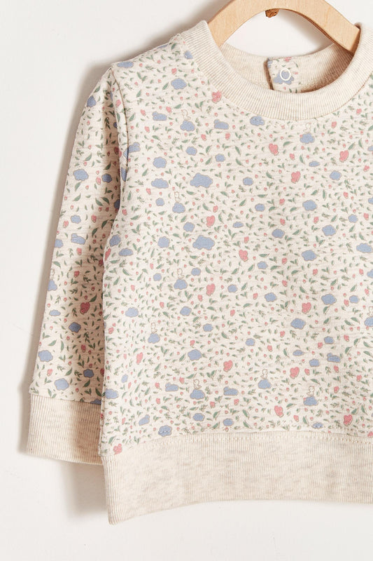 Keep your little one warm and comfortable with our baby sweatshirt, fully printed with our cutest Fall in Love print. Round neckline and snaps closure at the back. Match it with our Fall in Love pants for the sweetest look! Colour: Beige melange with pink and light-blue details. Composition: 100% Peruvian Pima cotton.  Made in Peru. Machine wash cold. 