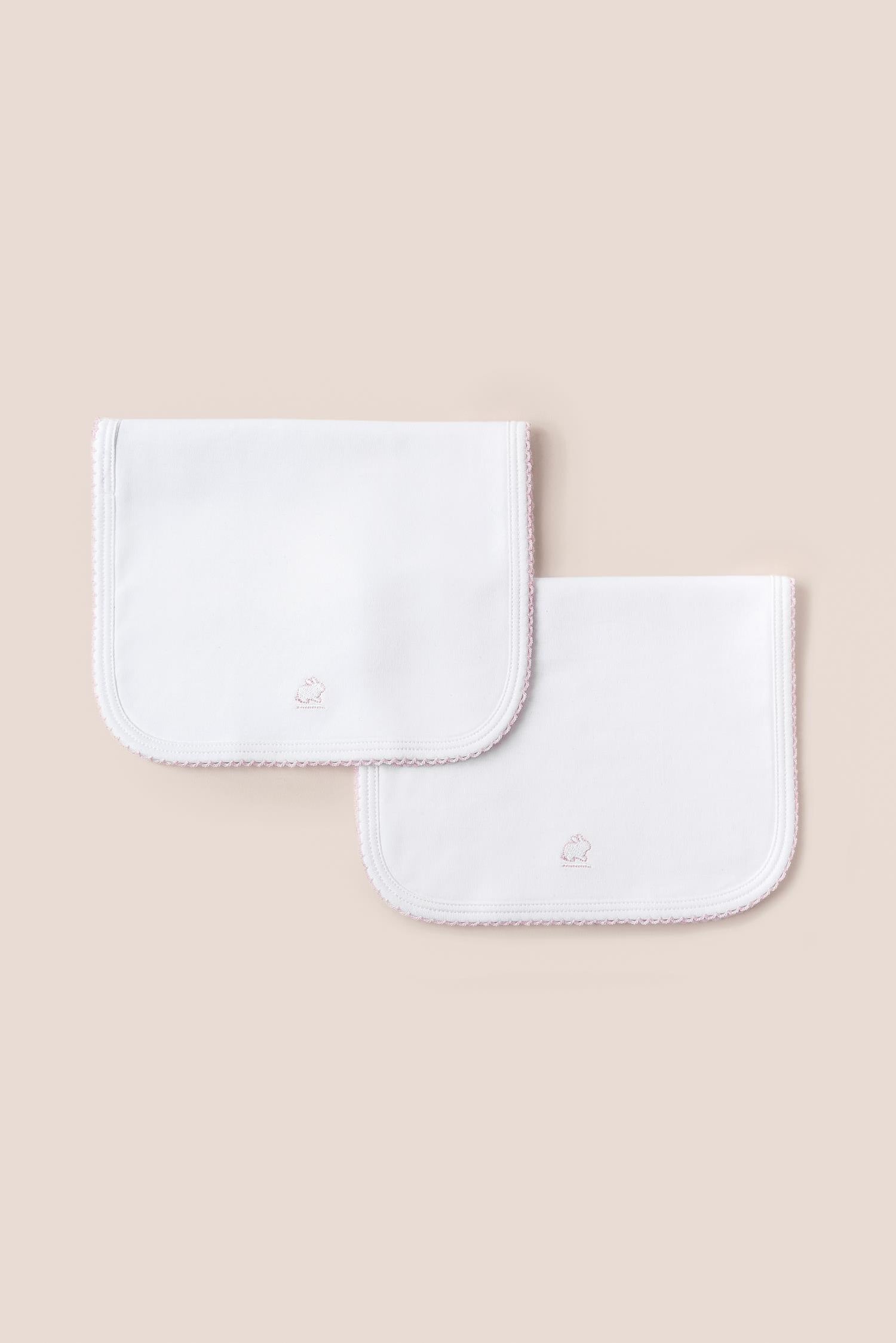 Essential set of two cute and ultra soft burp cloths, a must have for your little one with our lovely logo embroidered! Two Pima cotton burp cloths of approx. 18 cm x 36 cm designed with picot edging.  Reverse side has absorbent towel for extra comfort. This product is a MUST have! Composition: 100% Pima Cotton.  Made in Peru.  Machine washable.