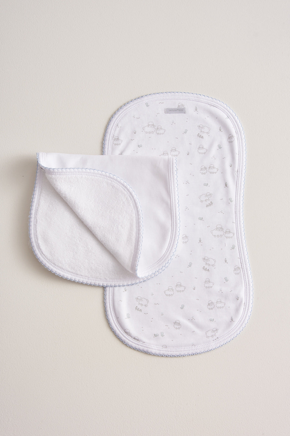 Essential set of two cute and ultra soft burp cloths, a must have for your little one with our lovely Fluffy Sheep embroidered! Two Pima cotton burp cloths of approx. 18 cm x 36 cm designed with picot edging.  Reverse side has absorbent towel for extra comfort. This product is a MUST have! Composition: 100% Pima Cotton.  Made in Peru.  Machine washable.