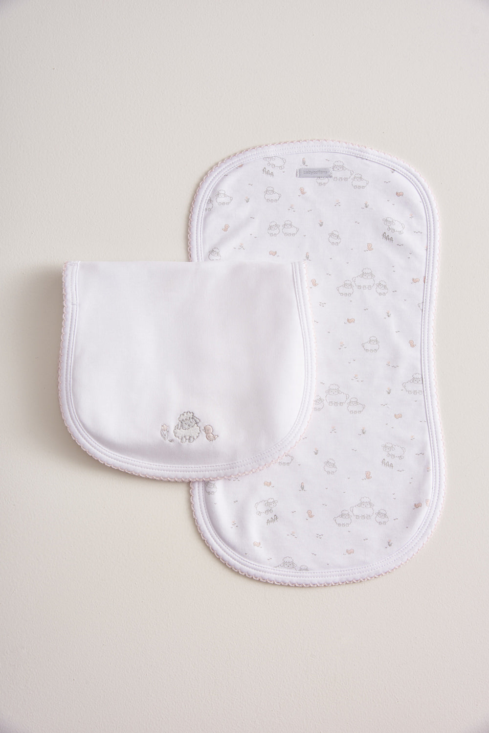 Essential set of two cute and ultra soft burp cloths, a must have for your little one with our lovely Fluffy Sheep embroidered! Two Pima cotton burp cloths of approx. 18 cm x 36 cm designed with picot edging.  Reverse side has absorbent towel for extra comfort. This product is a MUST have! Composition: 100% Pima Cotton.  Made in Peru.  Machine washable.