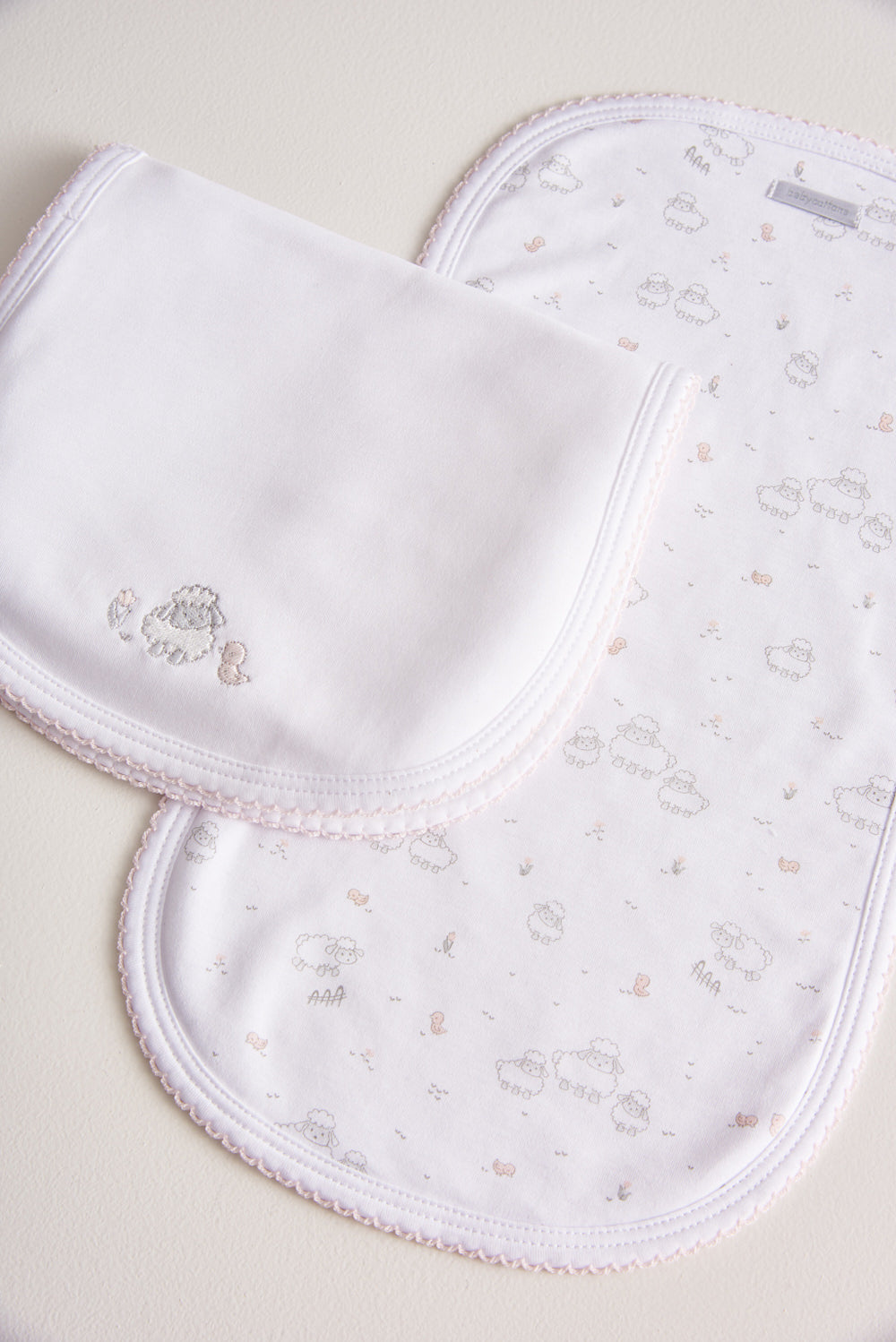 Essential set of two cute and ultra soft burp cloths, a must have for your little one with our lovely Fluffy Sheep embroidered! Two Pima cotton burp cloths of approx. 18 cm x 36 cm designed with picot edging.  Reverse side has absorbent towel for extra comfort. This product is a MUST have! Composition: 100% Pima Cotton.  Made in Peru.  Machine washable.