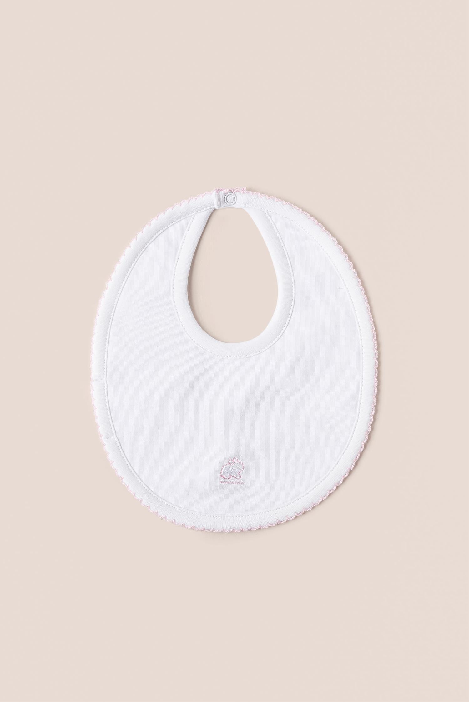 Cute and soft bib to keep your little one of up to 3 months dry and clean!  This small cotton bib has absorbent towel on the reverse side and a single snap closure at the back for comfortable wear. Designed with white rib and white stitching and our signature bunny embroidery at front. Composition: 100% Peruvian Pima Cotton.  Made in Peru.  Machine washable. 