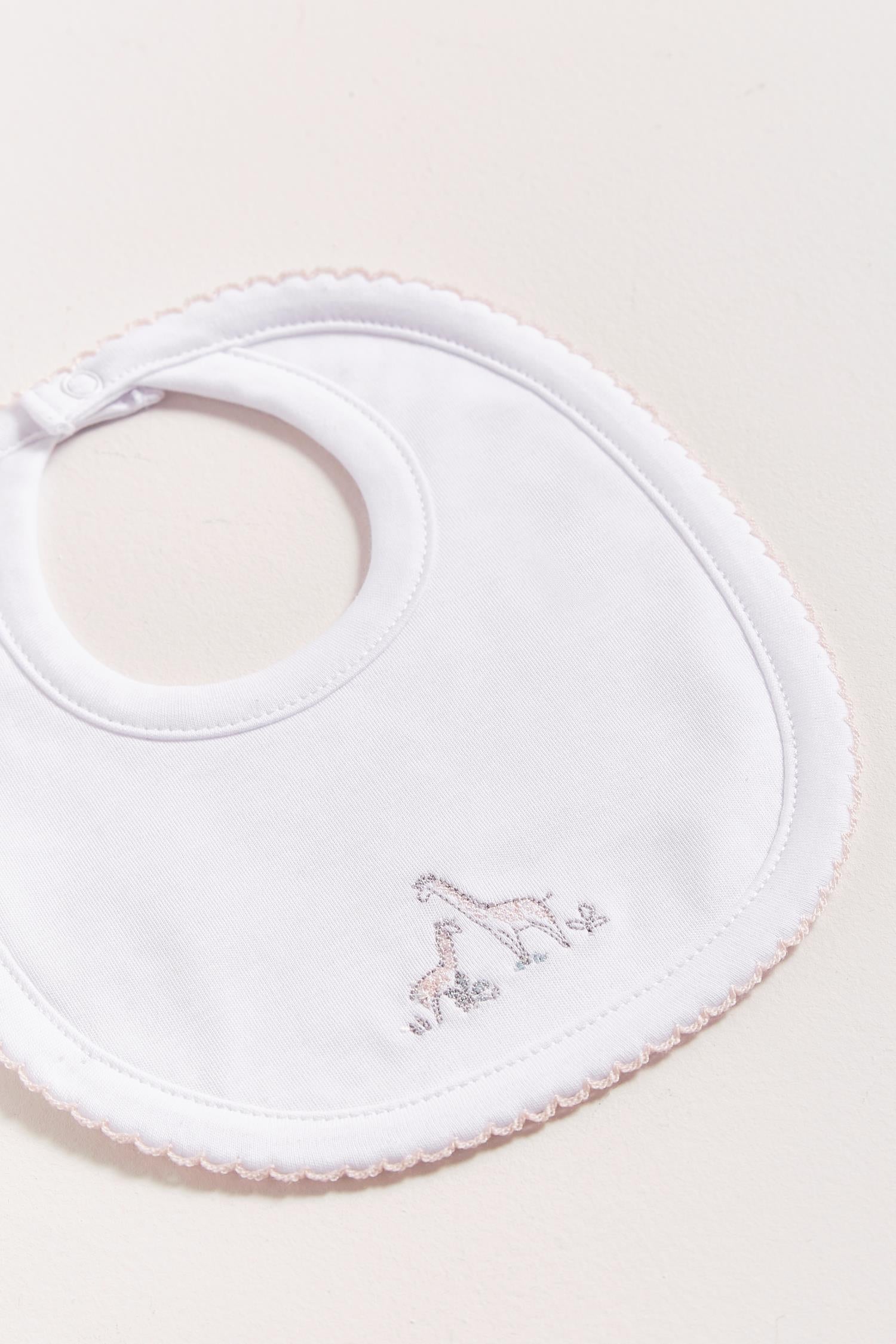 This Mini Safari bib is perfect to fit your baby from 0 to 6 months. It not only helps to keep teething baby dry and neat, but is also versatile enough for any daily outfit. Front side comes with embroidered giraffes from the collection. The reverse side has an absorbent towel for an extra comfort. Composition: 100% Peruvian Pima Cotton.  Made in Peru.  Machine washable.  