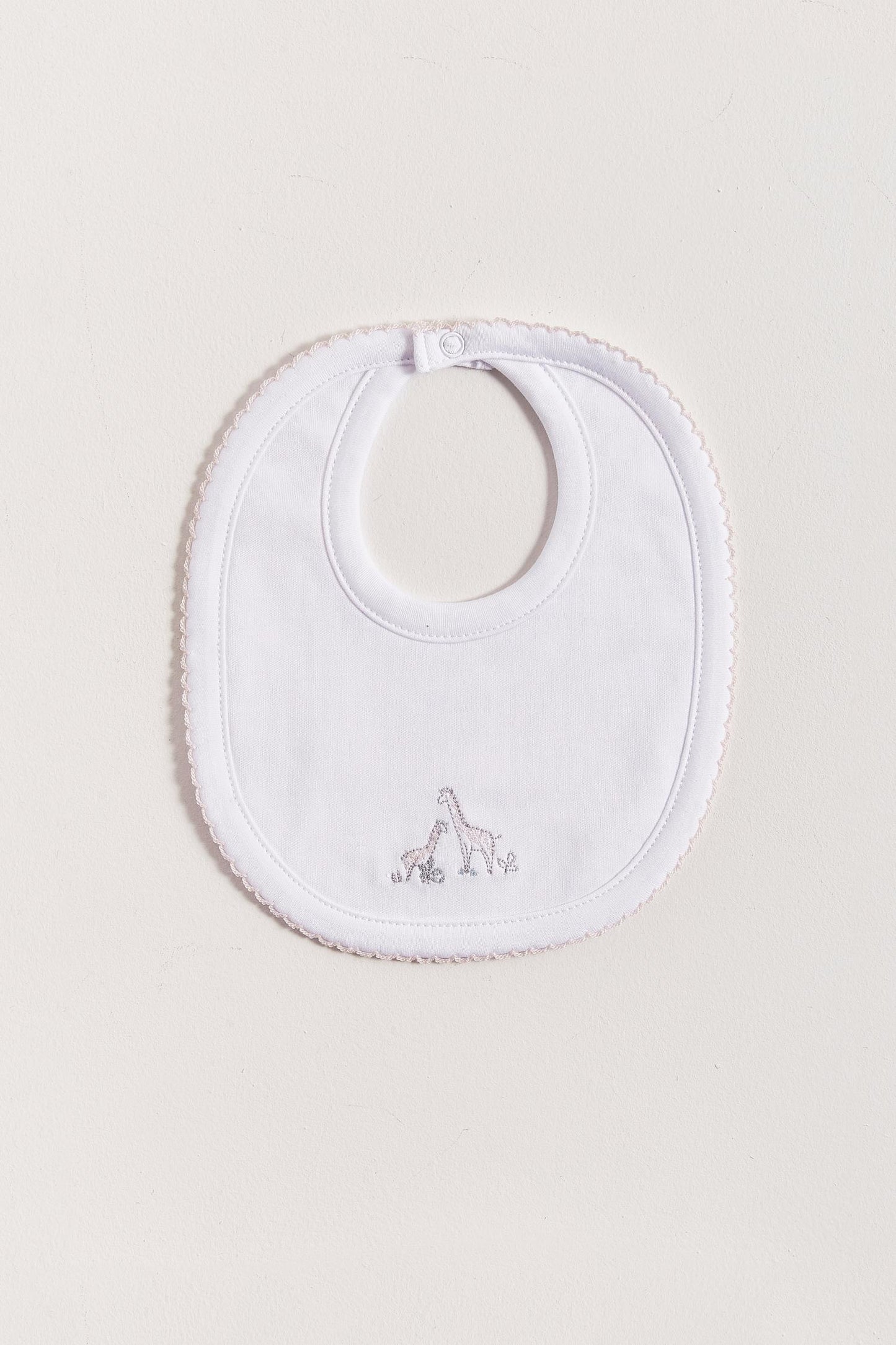 This Mini Safari bib is perfect to fit your baby from 0 to 6 months. It not only helps to keep teething baby dry and neat, but is also versatile enough for any daily outfit. Front side comes with embroidered giraffes from the collection. The reverse side has an absorbent towel for an extra comfort. Composition: 100% Peruvian Pima Cotton.  Made in Peru.  Machine washable.  