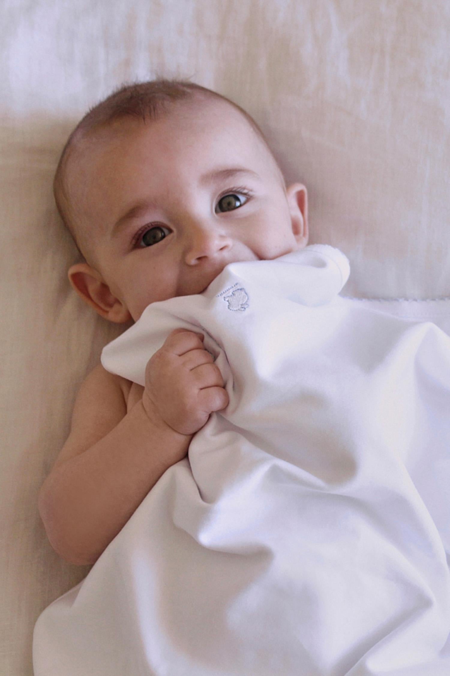Our plain blanket in double pima cotton is pure quality and durability and whelp keeping your baby's temperature regular!  Use it to lay over baby in your arms, in the pram or in the cot. It makes a great gift idea for a new baby or baby shower while combined with our softest pyjamas.  Choose from a beautiful array of classic colours: light-blue and white, pink and white or all white. Features our lovely logo embroidered on one side and a delicate picot finish on the edge. Measures: 73 cm x 69 cm 