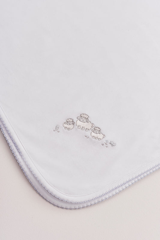 Crafted from super soft Pima cotton, this receiving blanket makes babies first months extra cozy. This two sided blanket features a sleek white finish with an embroidered Fluffy Sheep, while the other side comes with a full print of our lovely Fluffy Sheep collection. Approximate measurement: 100 cm x 100 cm. Composition: 100% Peruvian Pima Cotton.  Made in Peru.  Machine washable. 