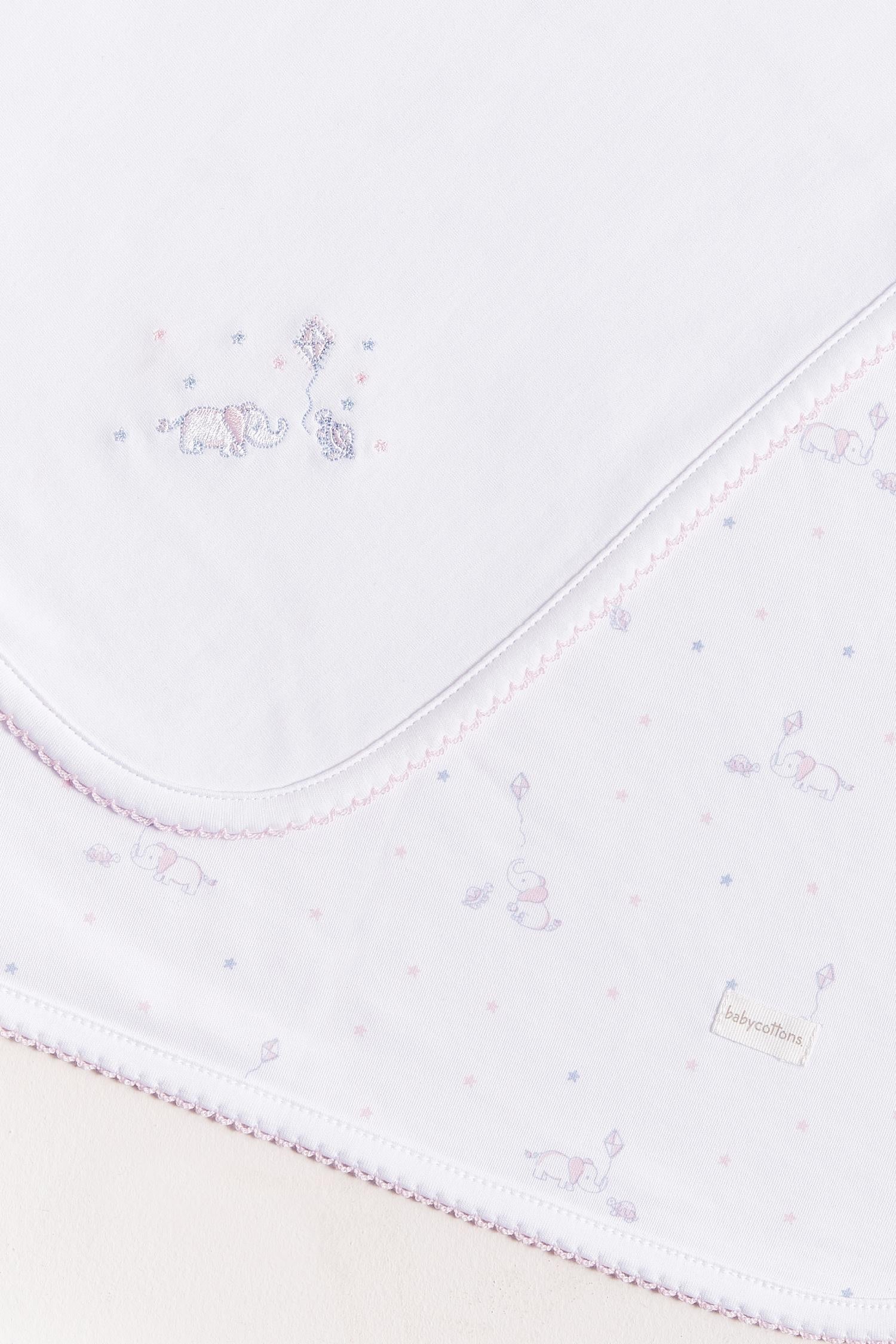 Crafted from super soft Pima cotton, this receiving blanket makes babies first months extra cozy.  This two sided blanket features a sleek white finish with an embroidered of Celine & Bernie, while the other side comes with a full print of our Celine & Bernie collection. Composition: 100% Peruvian Pima Cotton.  Made in Peru.  Machine washable. 